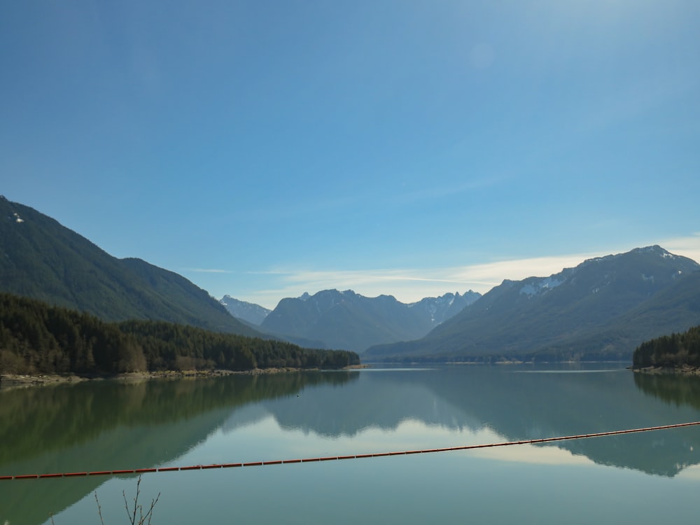 a body of water with mountains in the background