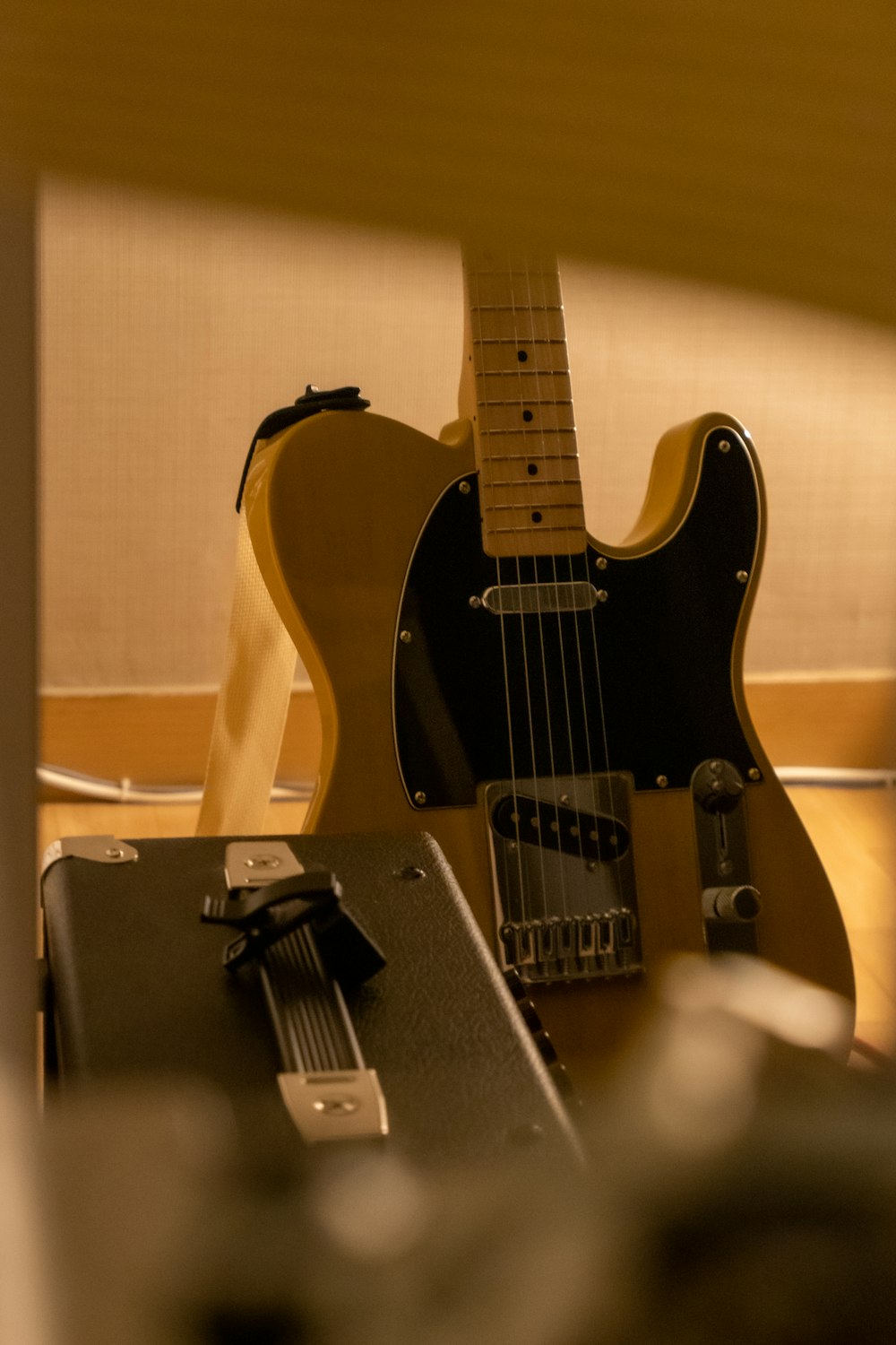 a guitar and a case sitting on a table