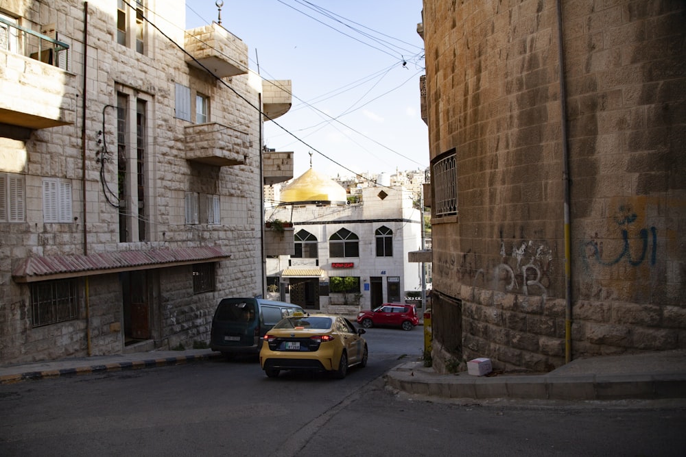 a car parked on the side of a road next to a building