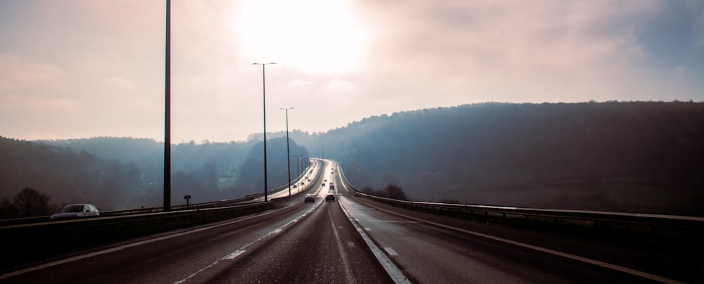 the sun is shining down on a highway