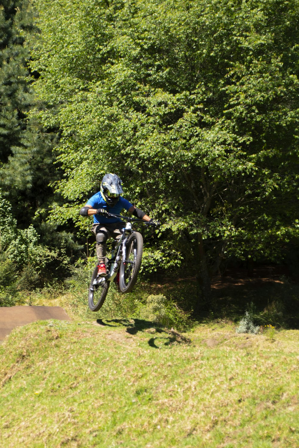 a person on a bike jumping over a hill