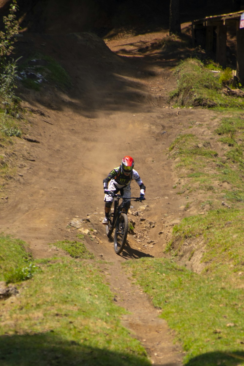 a man riding a bike down a dirt road