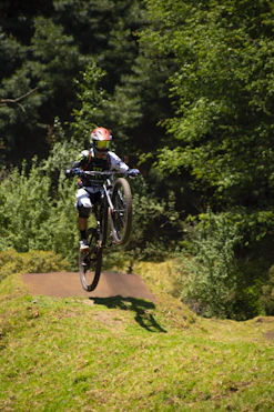 a person on a dirt bike jumping over a hill