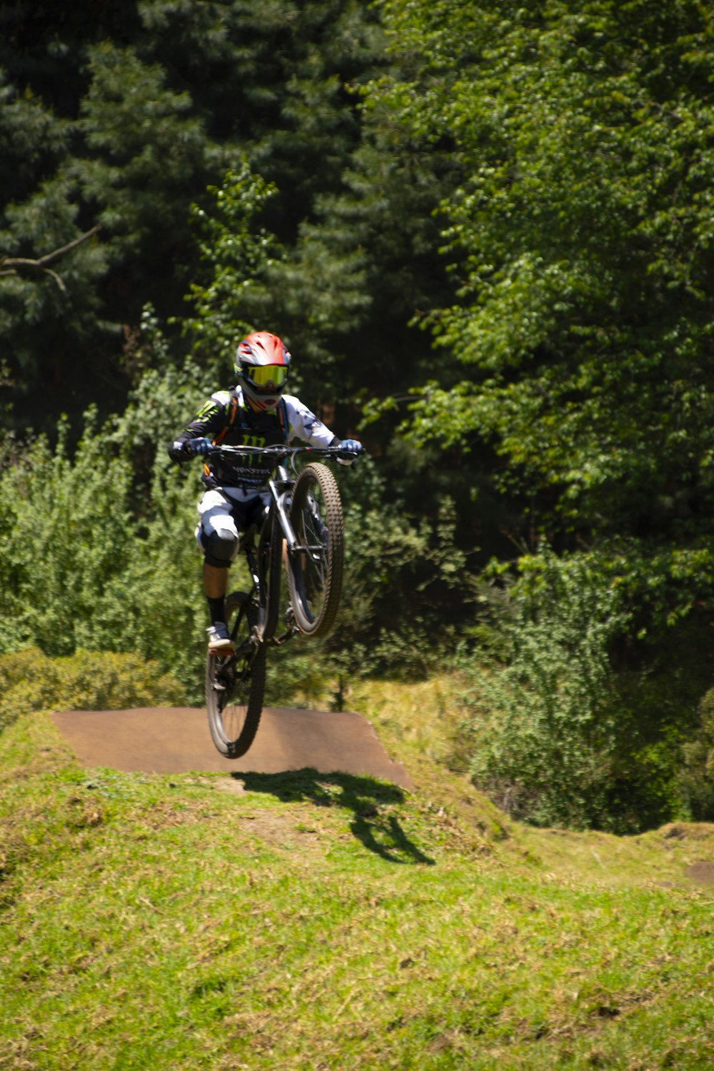 a person on a dirt bike jumping over a hill