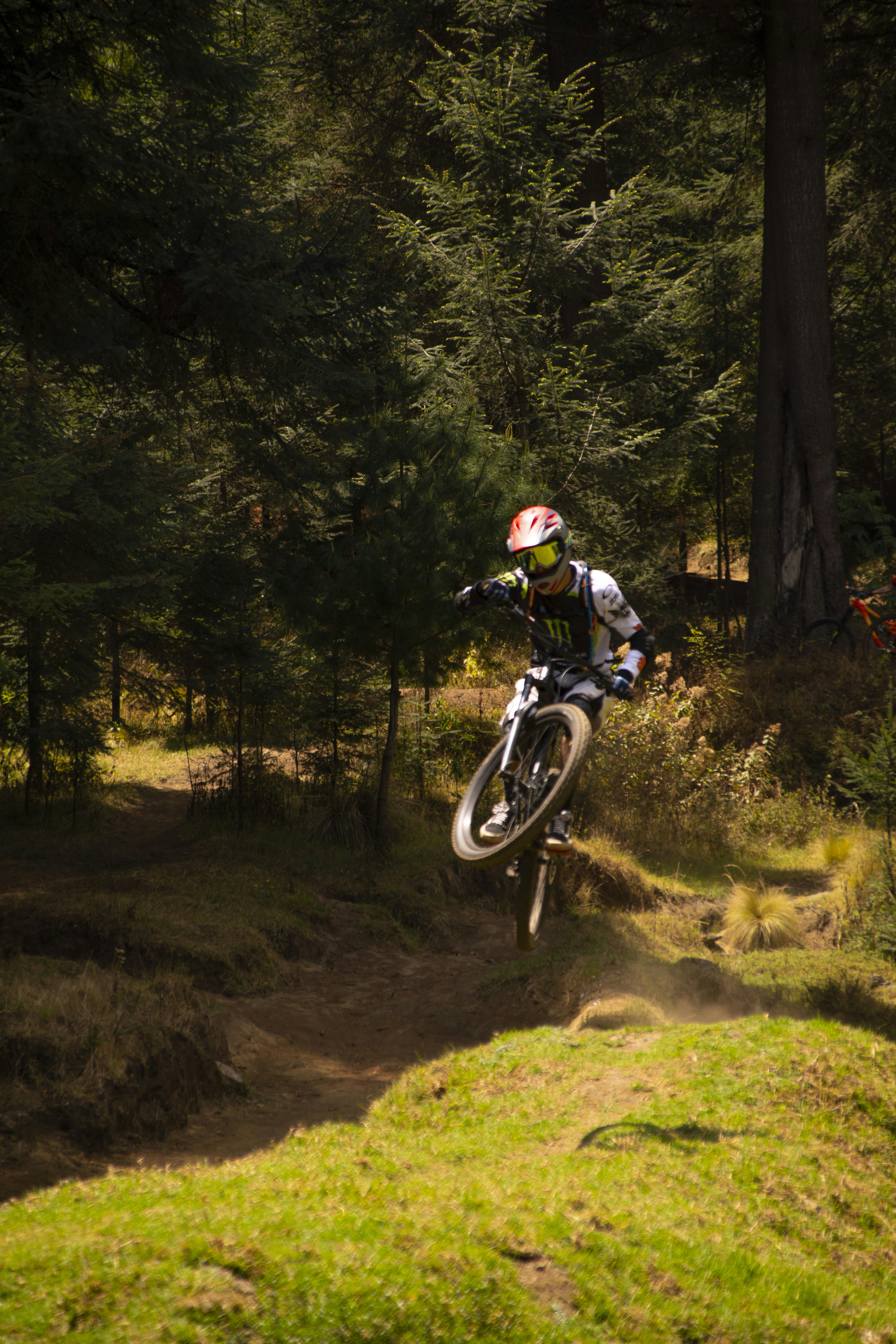 a person on a bike jumping over a hill