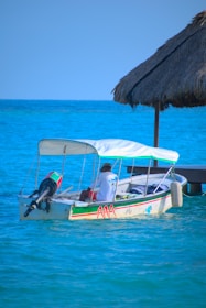 two people in a small boat in the ocean