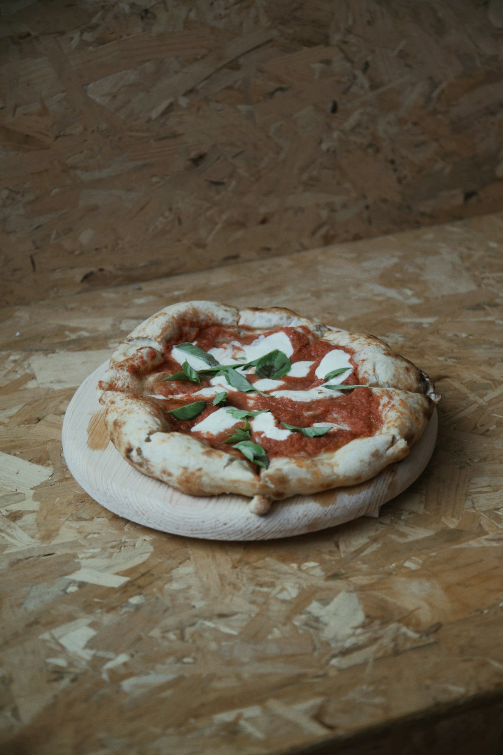 a small pizza sitting on top of a wooden table