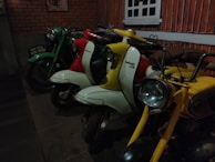 A retro wallpaper with multiple Vespa scooters in various colors.