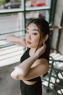 a woman in a black top posing for a picture