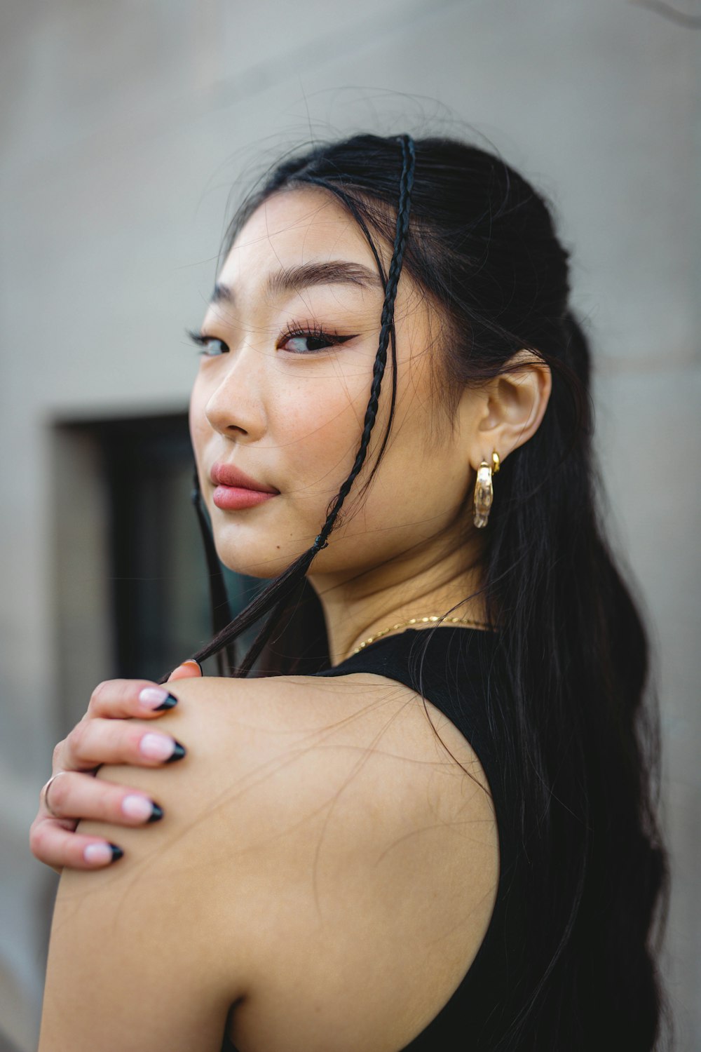 a woman with long hair wearing a black dress