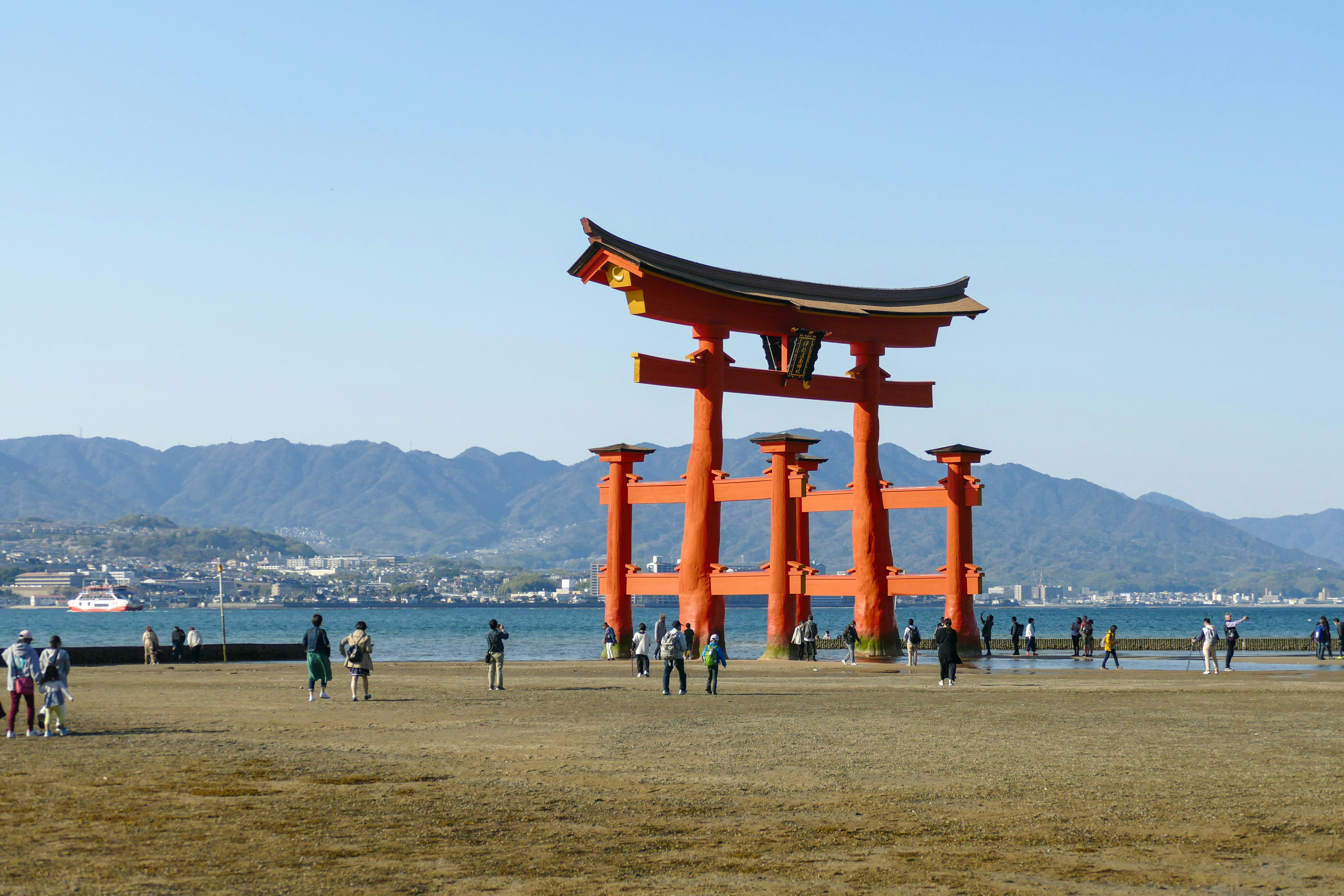 a group of people standing in front of a large orange gate