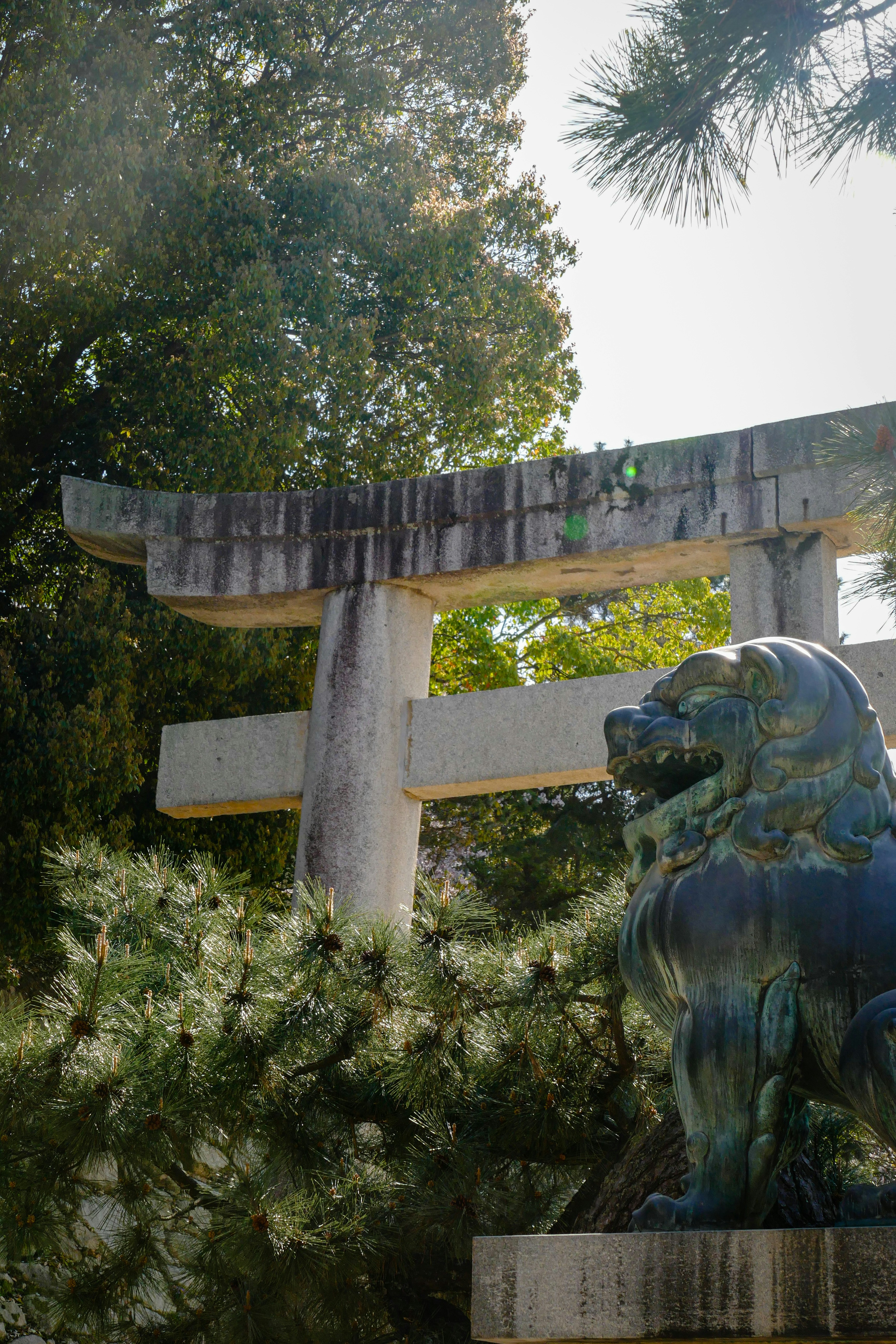 a statue of a lion in front of a cross