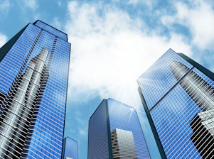 a group of tall buildings with a blue sky in the background