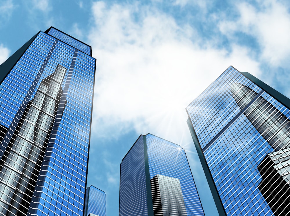 a group of tall buildings with a blue sky in the background