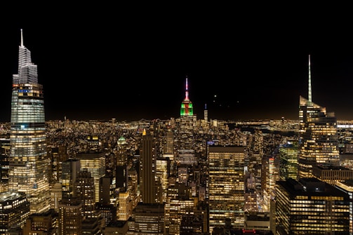 A vibrant city skyline at night, illuminated with deep reds and burgundy tones reflecting strength and leadership.