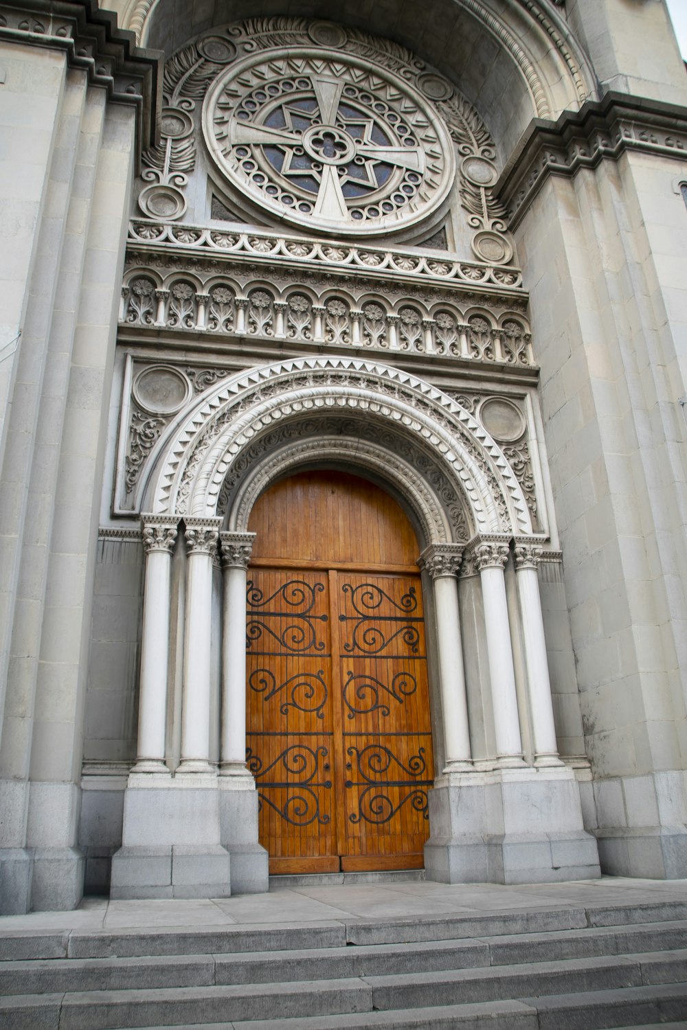 a large wooden door sitting in front of a tall building