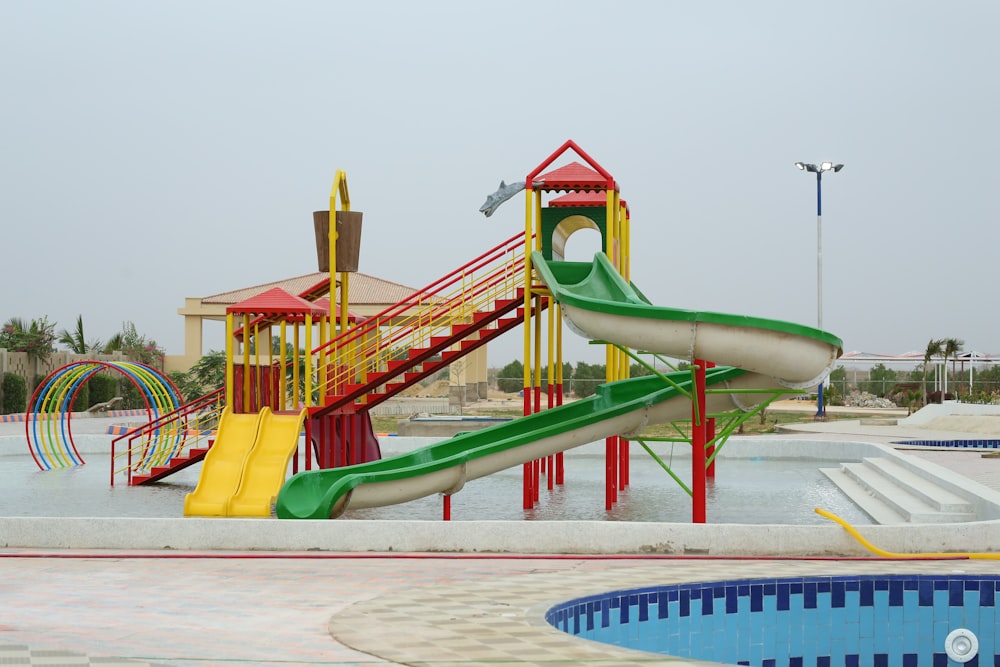 a water park with a water slide and a swimming pool