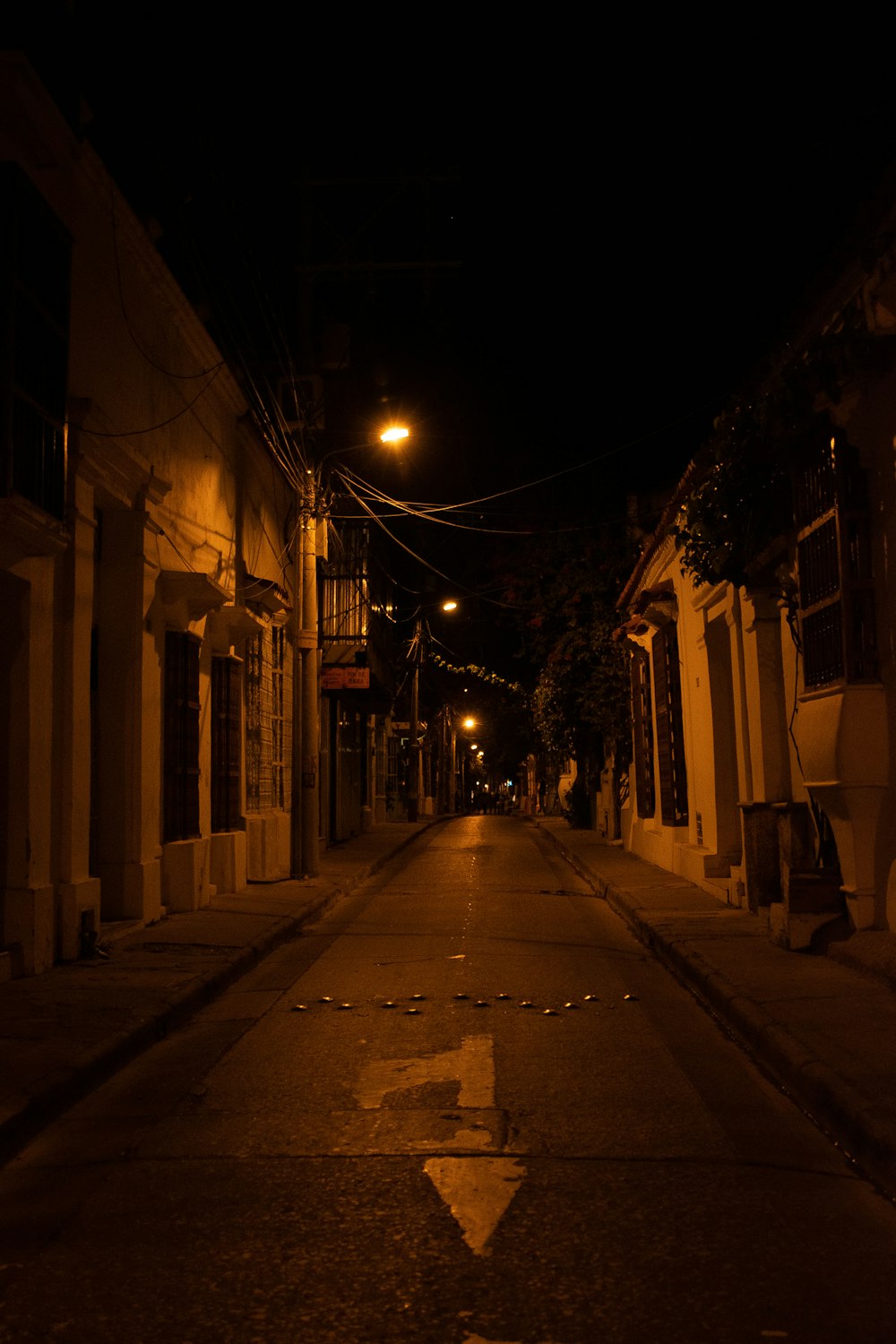 an empty street at night with no cars on it