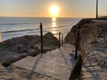 Pathway leading to the beach near the resort during golden hour.