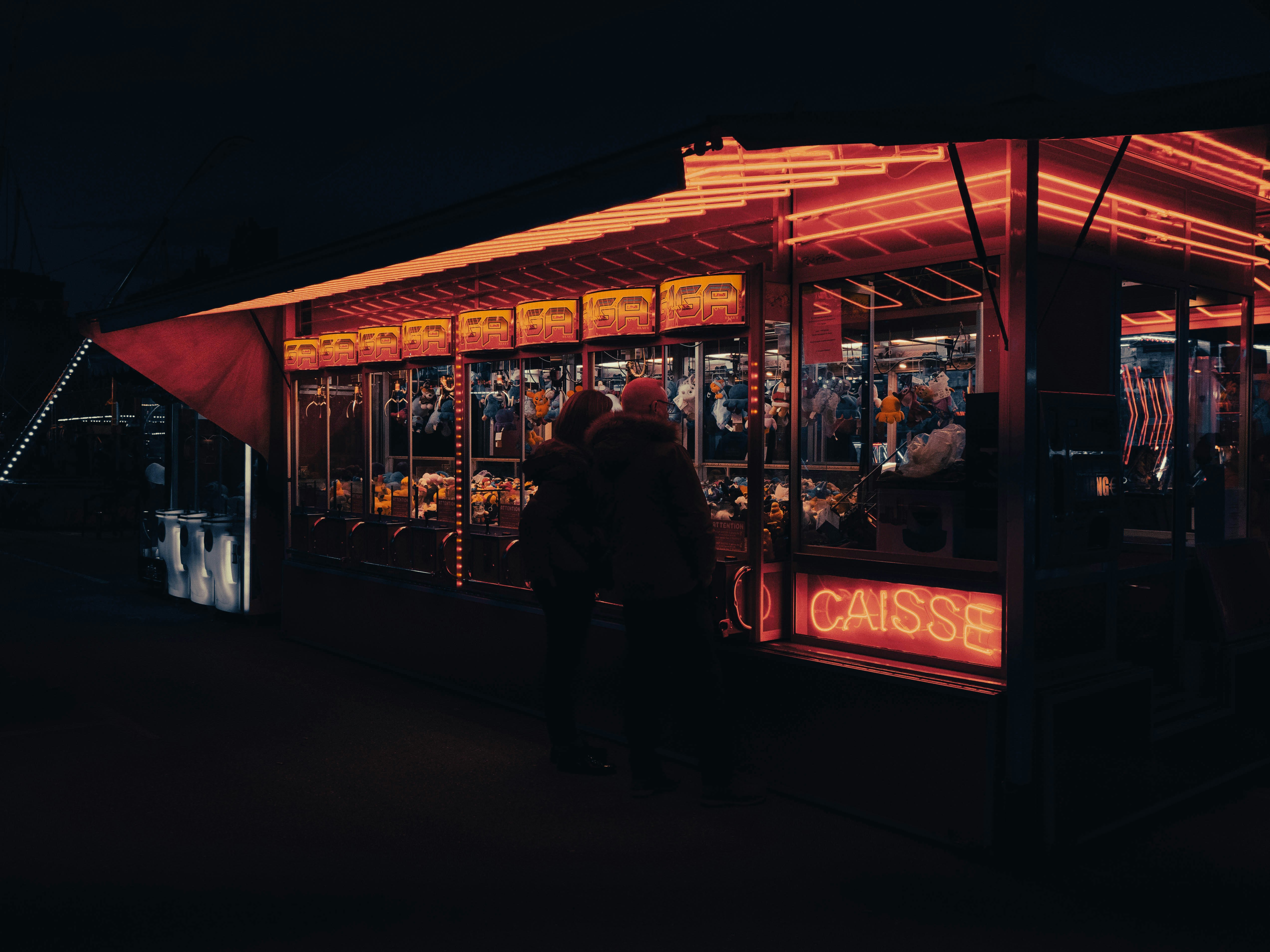 a couple of people standing outside of a food stand