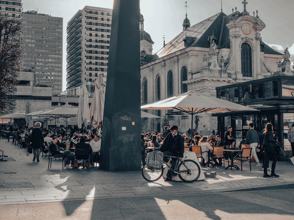 a bicycle parked next to a pole on a city street