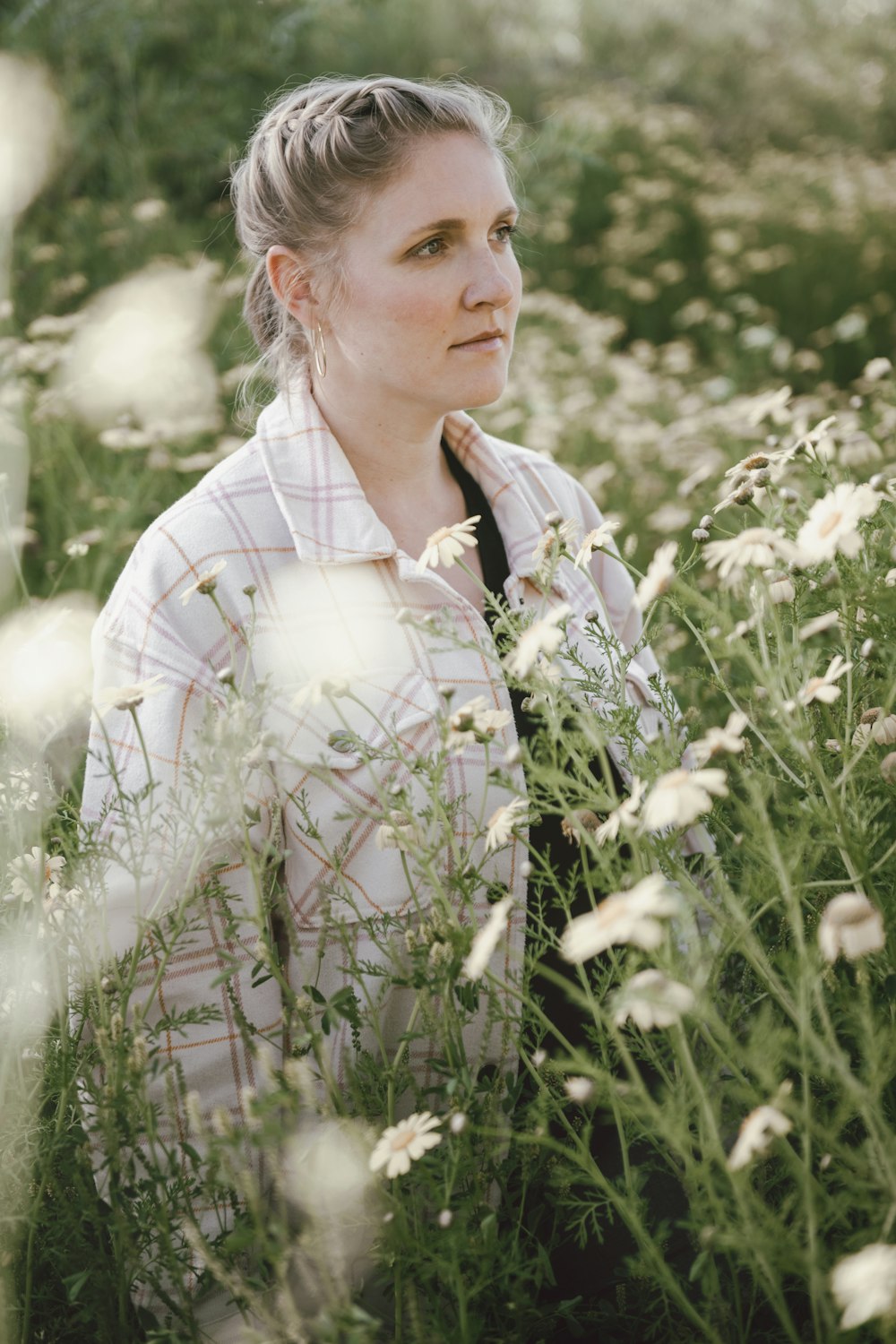 a woman standing in a field of flowers