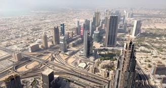 an aerial view of a city with train tracks