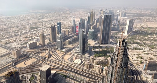 an aerial view of a city with train tracks