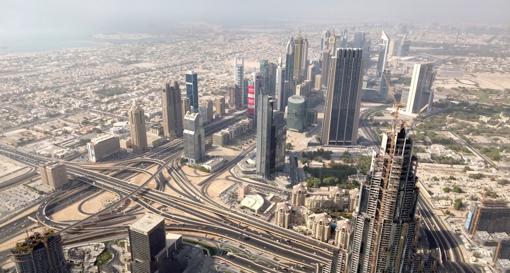 an aerial view of a city with train tracks