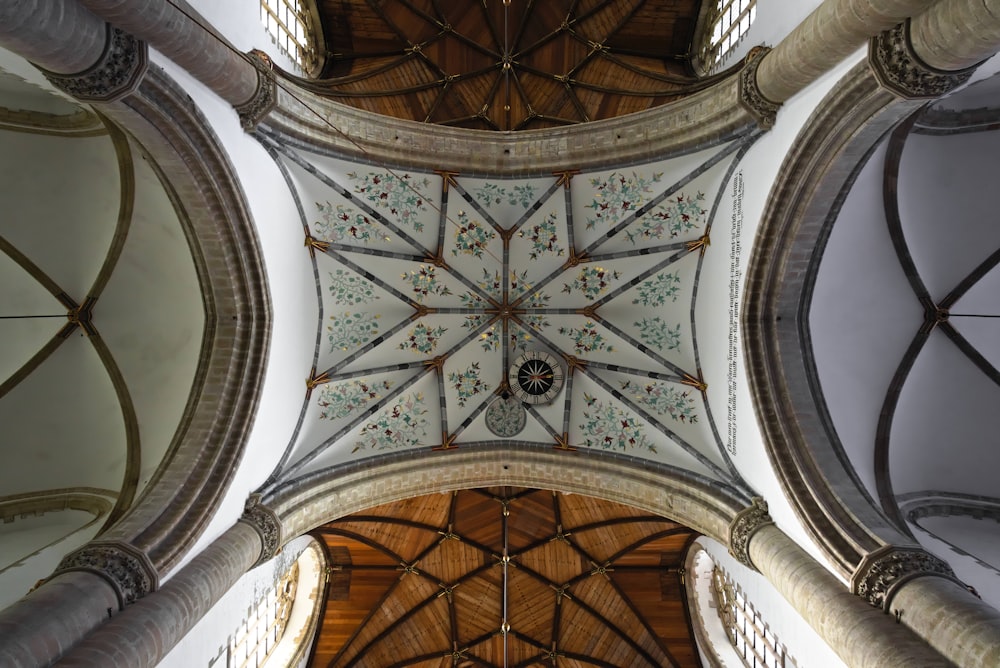 the ceiling of a large building with intricate designs