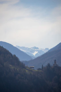 Cinematic aerial shot of a remote mountain village at dawn.