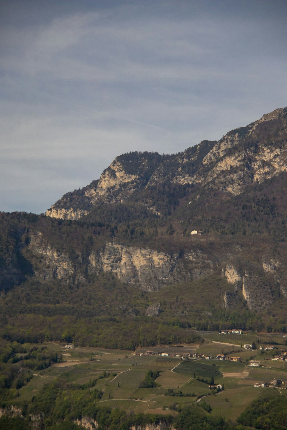 a view of a mountain with a village in the foreground