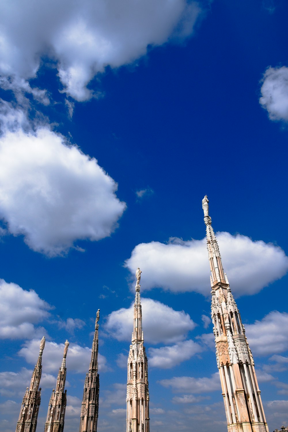 a group of tall buildings sitting under a blue sky