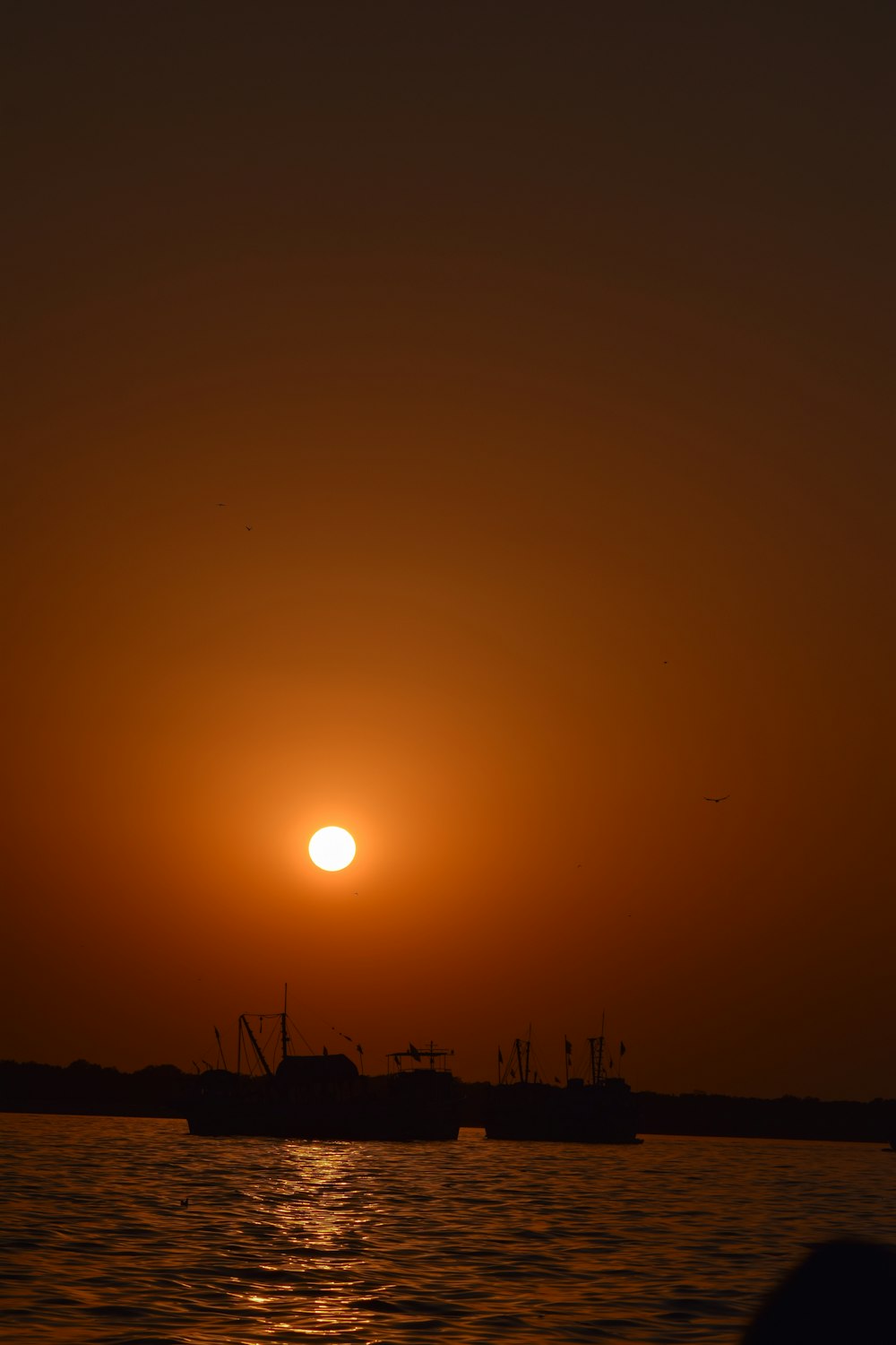 the sun is setting over a body of water