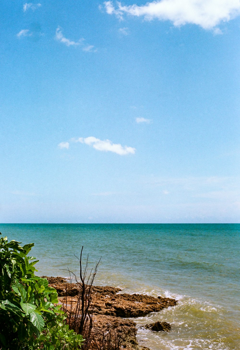 a view of the ocean from the shore of a beach