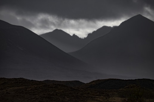 A dark, atmospheric book cover featuring eerie landscapes and shadowy figures.