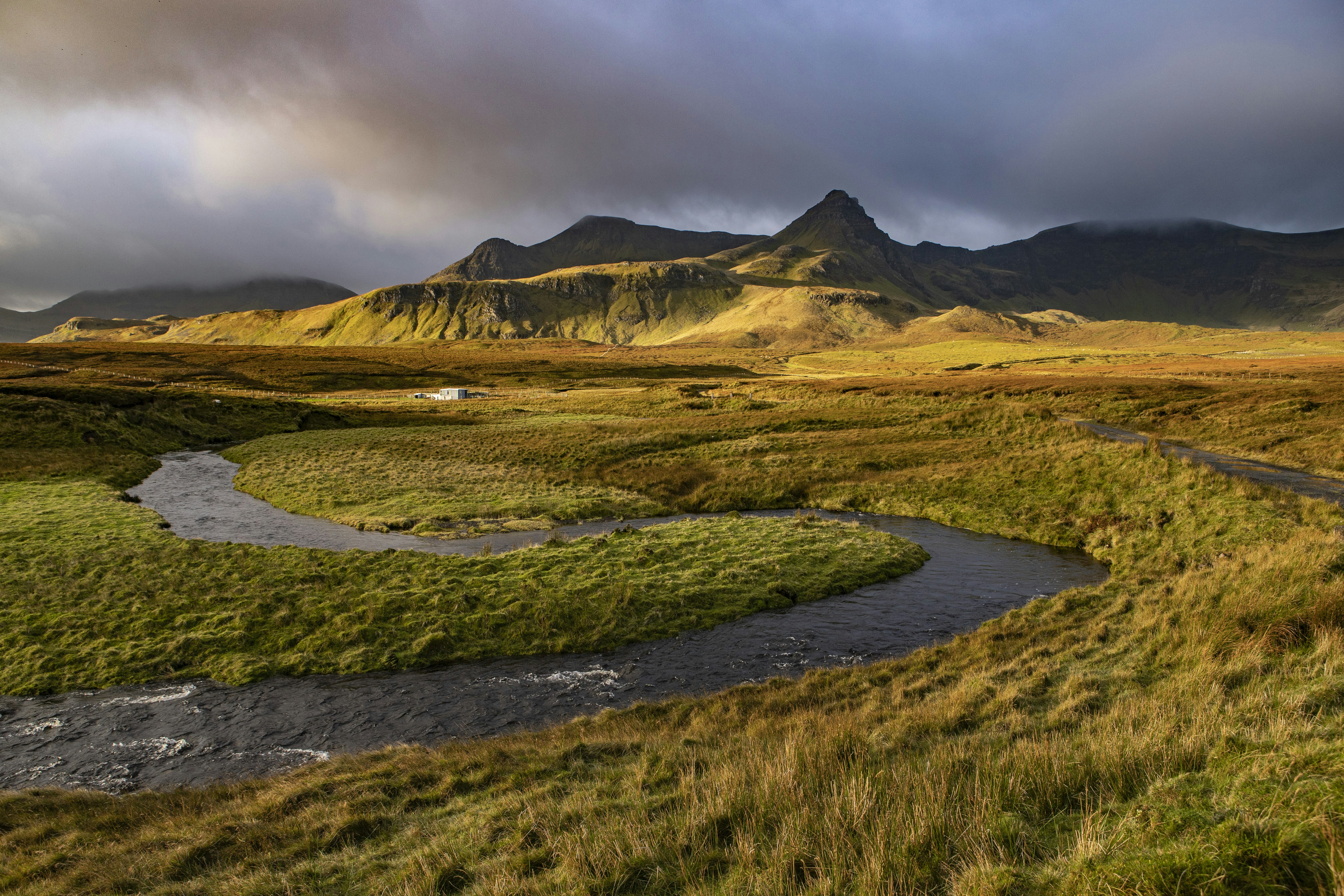 a river running through a lush green valley