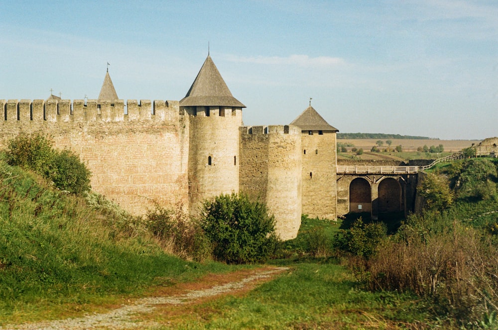 an old castle with a bridge going over it