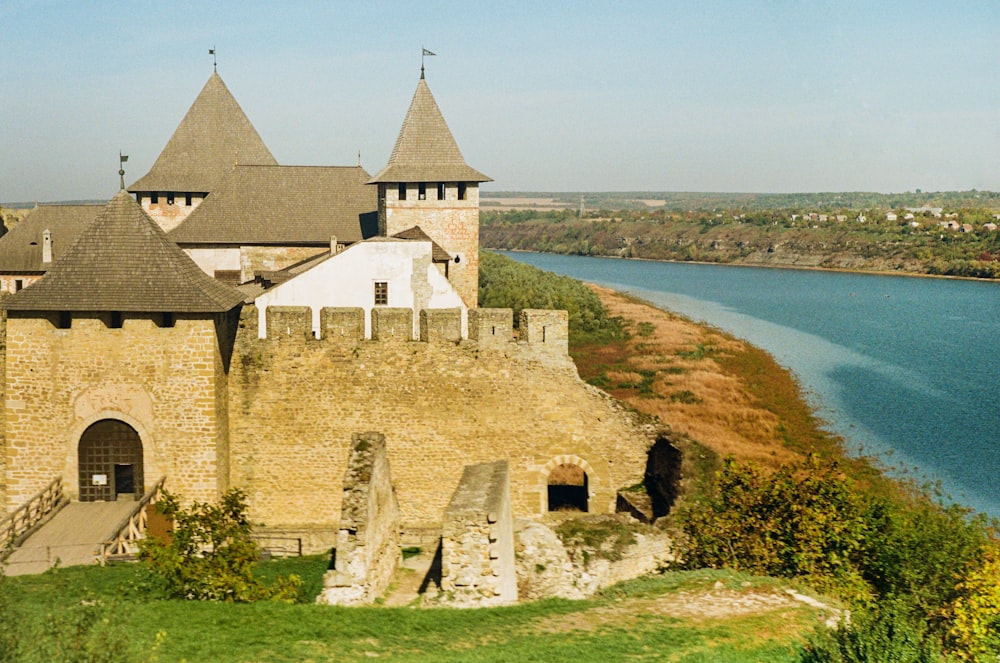 a castle with a river in the background