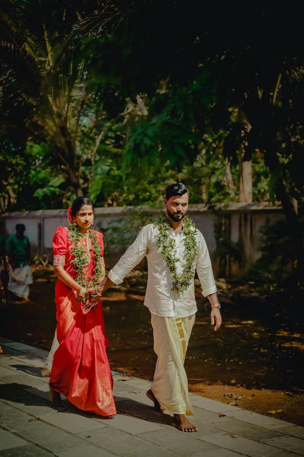 a man and woman walking down a street holding hands