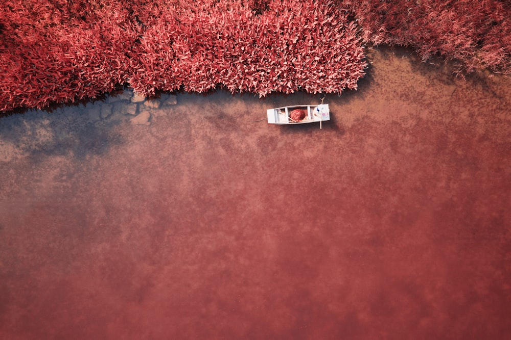 a small boat floating on top of a body of water