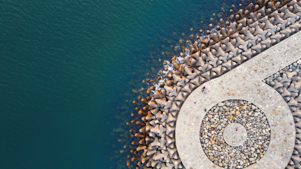 an aerial view of a stone pier with a spiral design