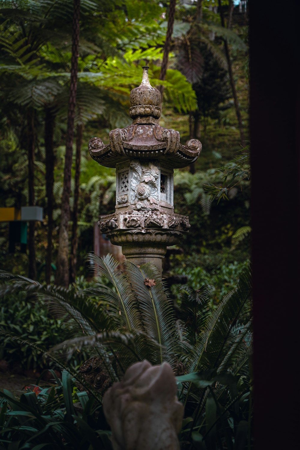 a stone lantern in the middle of a forest