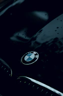 Side view of a sleek BMW with a deep glossy finish after ceramic coating treatment.