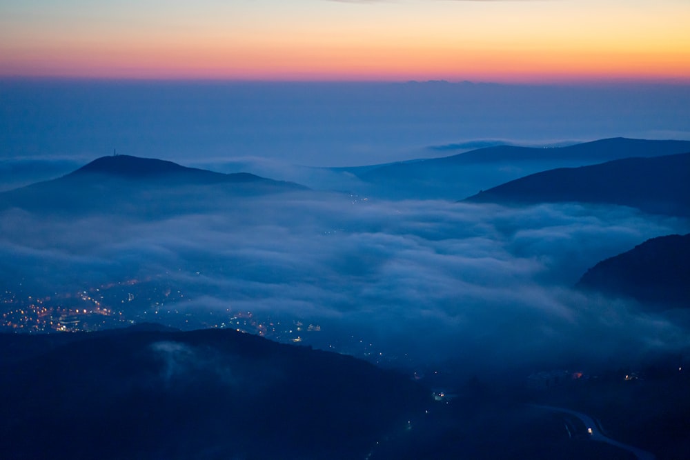 a view of a city below the clouds