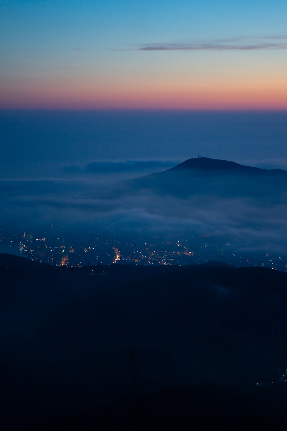 a view of a city below the clouds