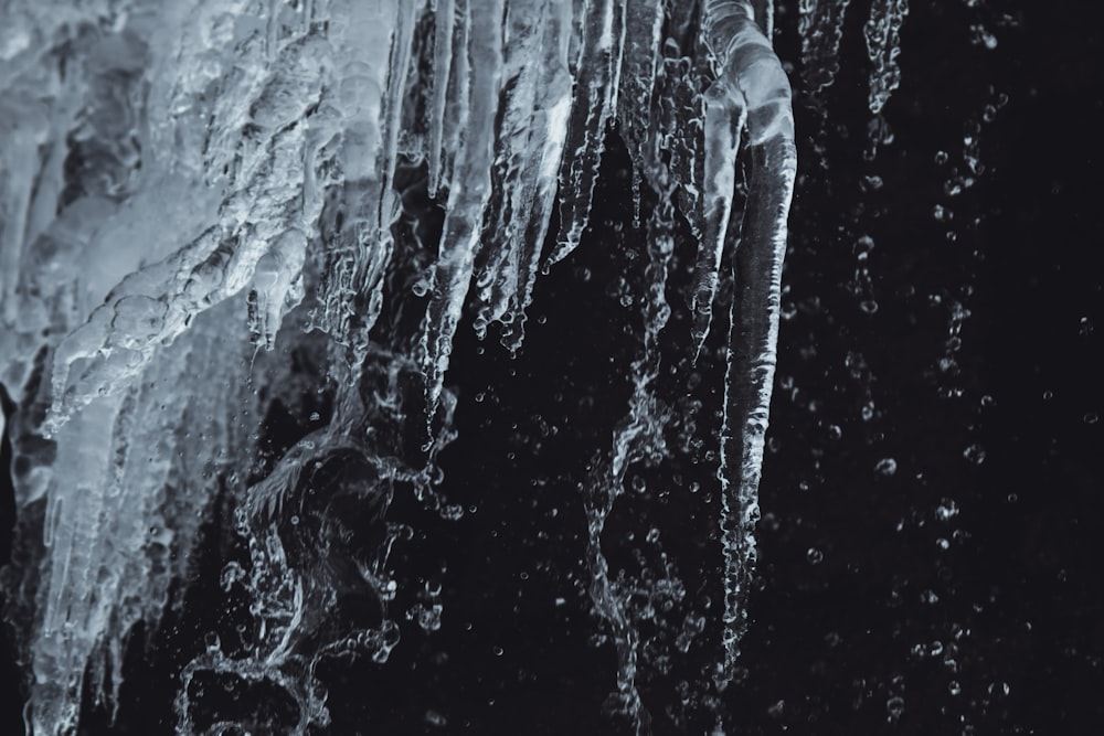 a close up of ice hanging from the side of a mountain