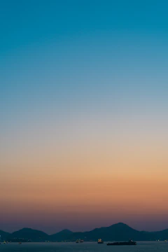 Landscape artwork showing serene sea horizon at sunrise.