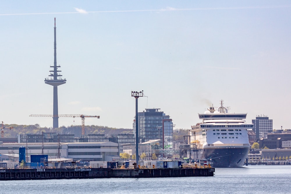 a large cruise ship in the water next to a dock