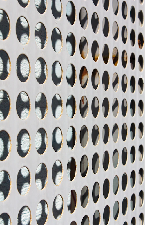 Vented soffit panel with airflow perforations